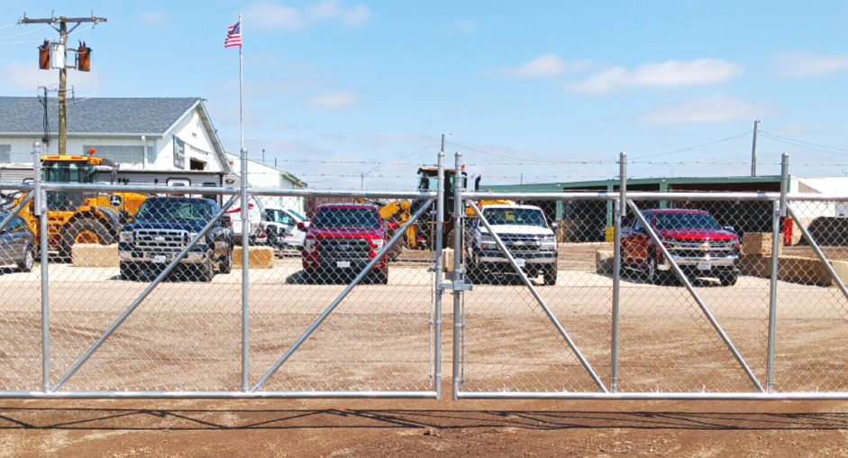 Cantilever double gate with barbed wire for a 48 foot opening at a trucking company,  Oswego
