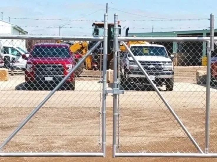 Cantilever chain link gate, entry gate for a trucking company.