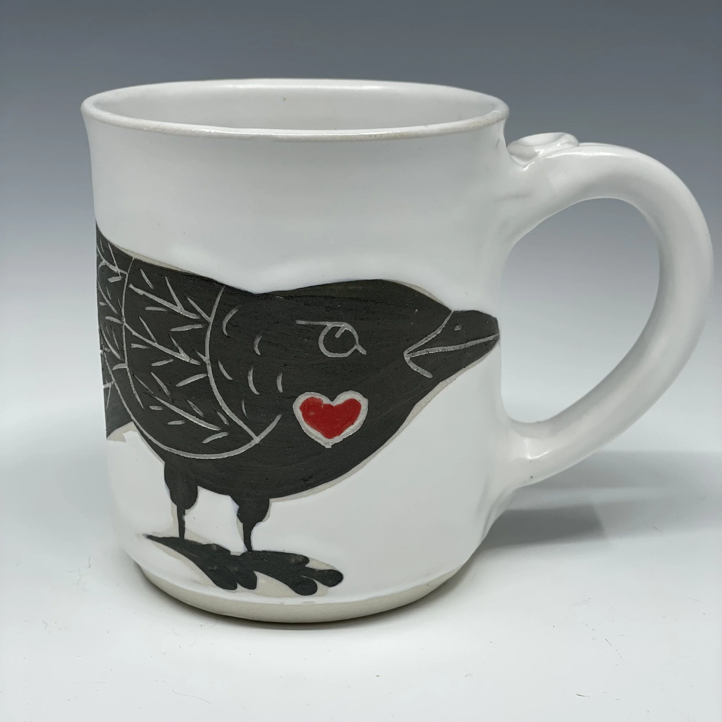 Raven with red heart mug
