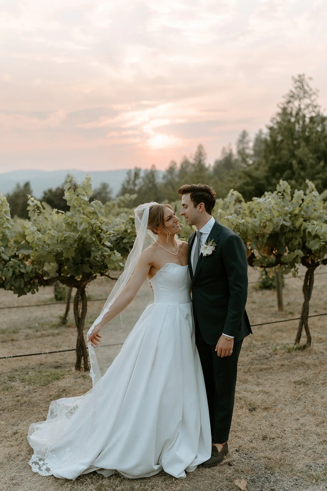 Wedding planner helping create the perfect golden hour photo.