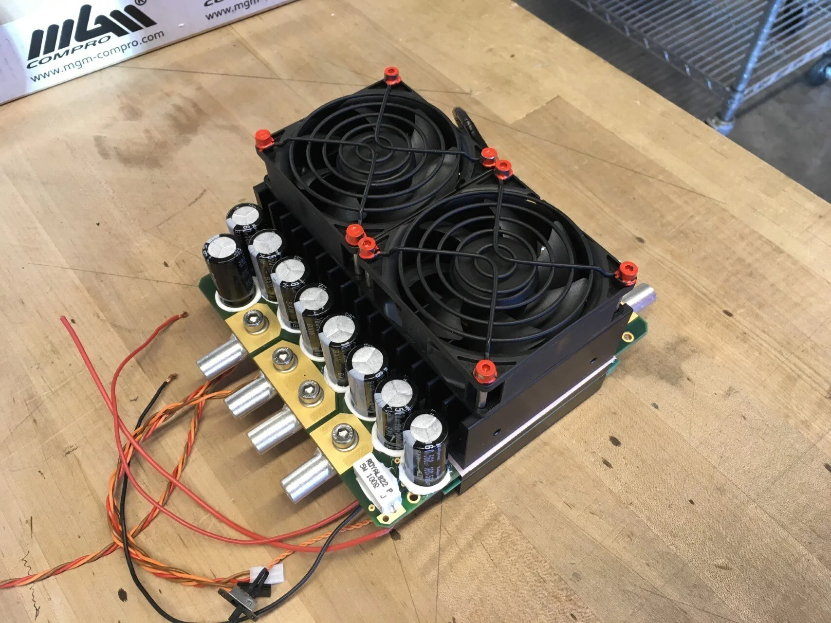   On the back side of the motor controller is visible the heat sink with cooling fans. The quality Rubycon input capacitors are encouraging.  