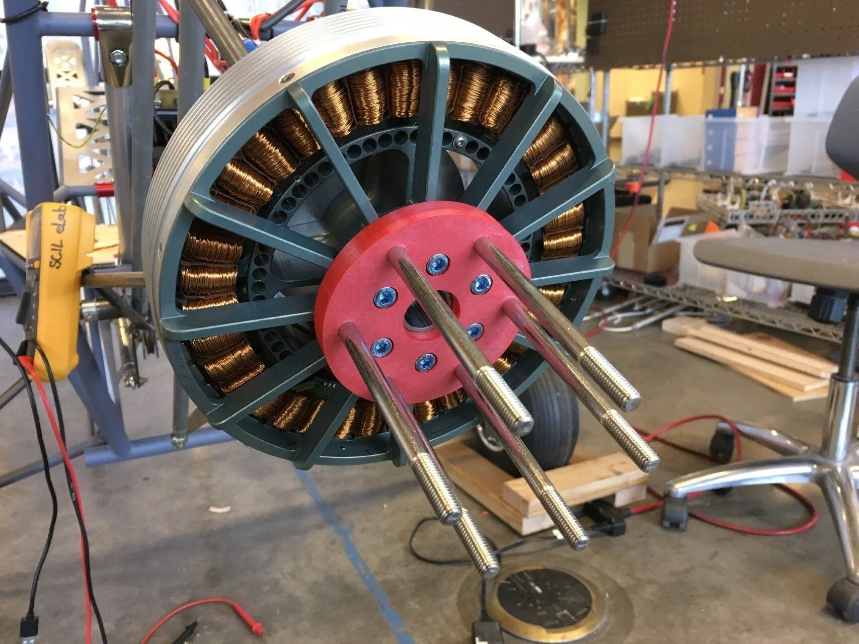   Aft view of the motor. The red disk is a 3D printed mock-up of the motor-to-propeller adapter plate. The prop we will be using requires the standard Rotax 6M8d75 hub bolt pattern. The plate will later be machined from aluminum.  
