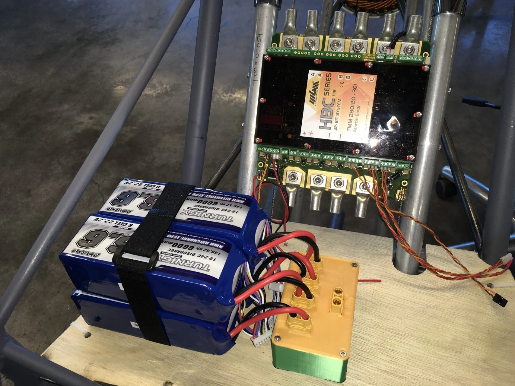   The motor controller is temporarily attached to the fuselage frame. A wooden platform is also installed to support the balance of our test setup.  