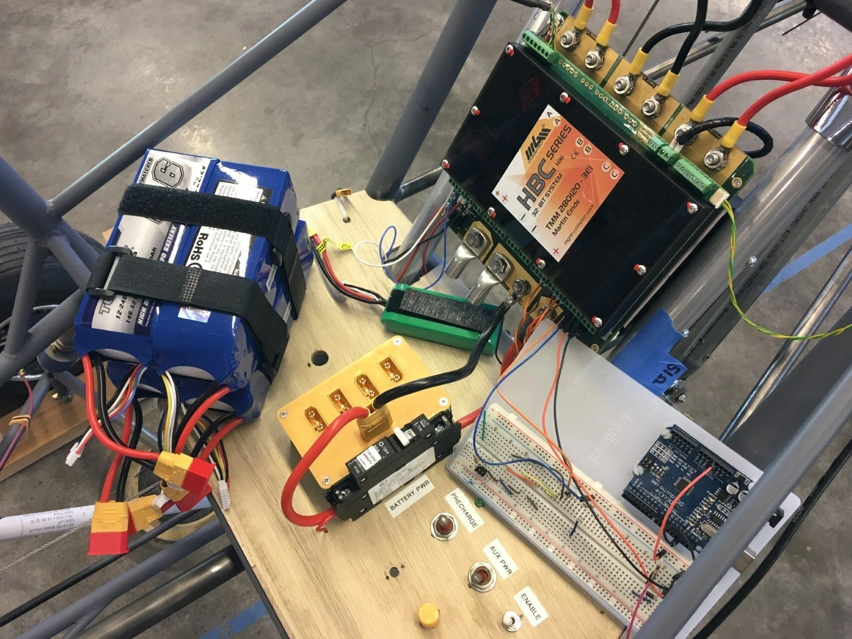   The control panel from left to right: circuit breaker, precharge switch, auxiliary power (12V control electronics), and controller enable switch. The potentiometer knob is below the aux power switch. The Arduino will be used to read performance dat