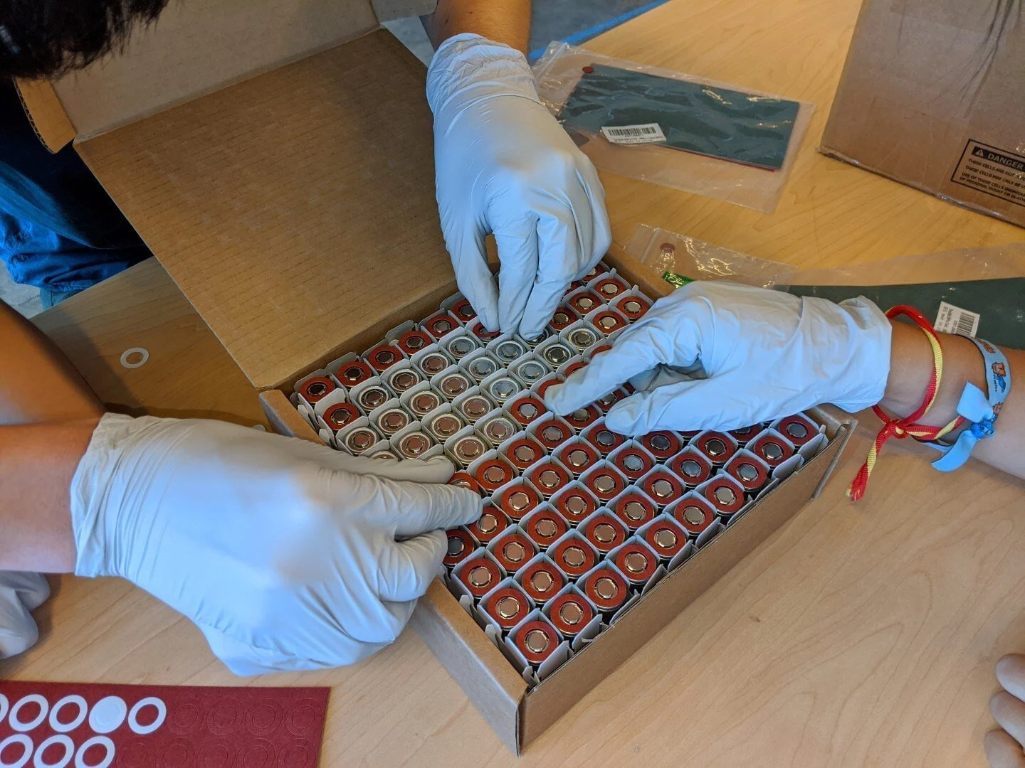 The cells arrived bare (no insulating washers or heat shrink wrap). After we measured the voltage of all cells to make sure we had no duds, we began to install the insulators and heat shrink.