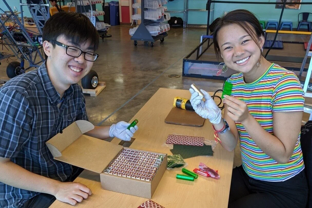 Workers demonstrate contentment early in the battery pack fabrication process.