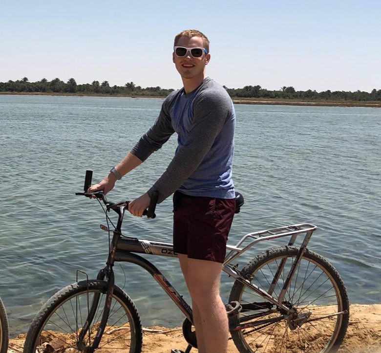 Gus on a bike in Siwa.png