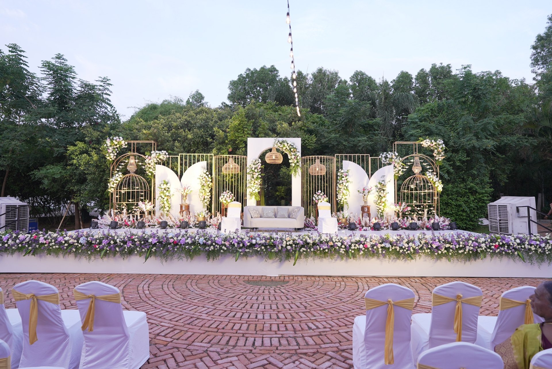 Zero waste wedding reception with natural lighting and minimal decor at an outdoor garden venue