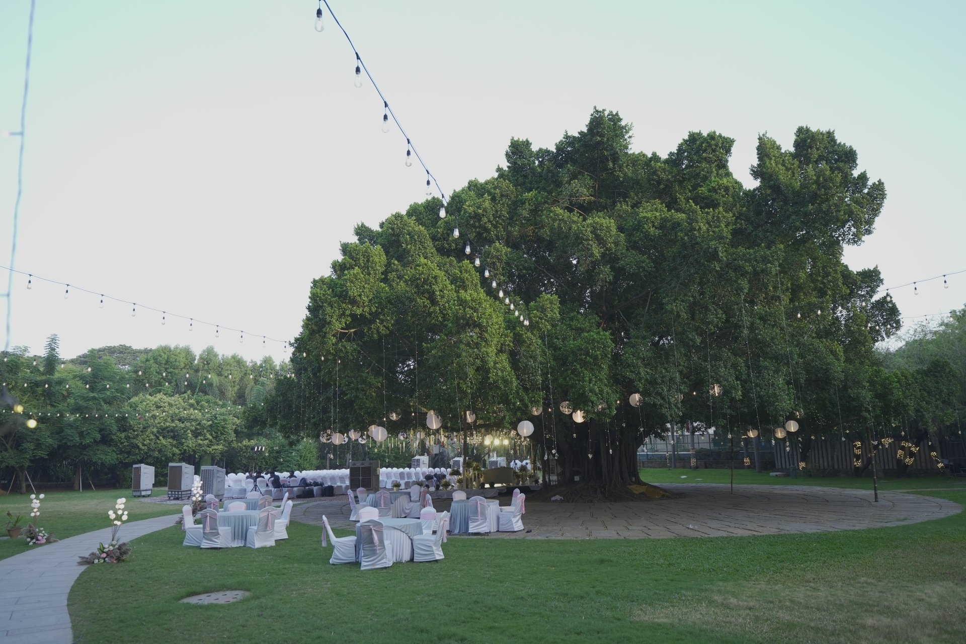Perfect outdoor wedding setup at Ficus Lawn SPP Gardens Chennai with fairy lights and floral mandap