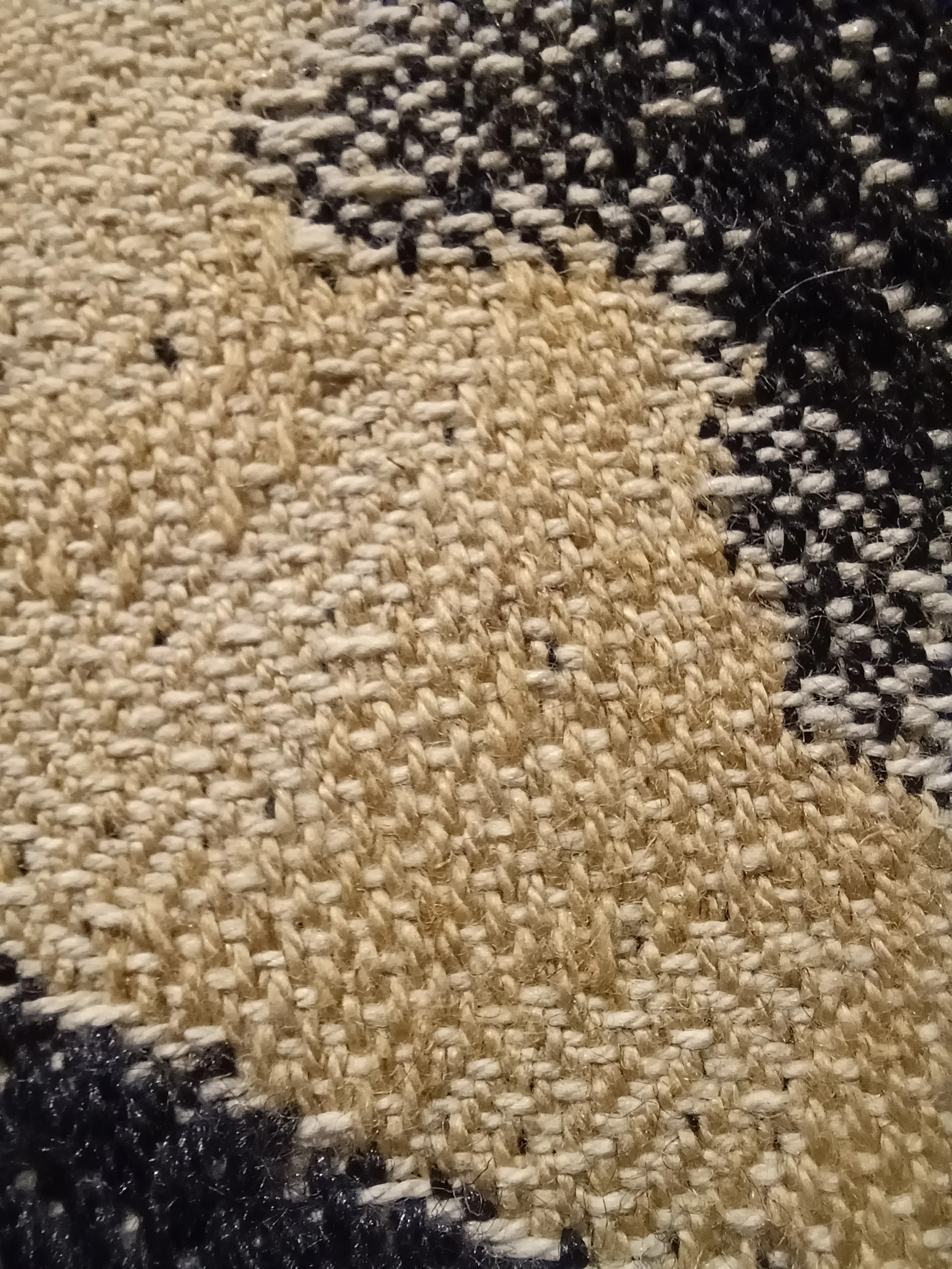 Close-up of woven tapestry, showing details of the fabric's structure composed of dyed cotton-linen and wool-silk yarns.