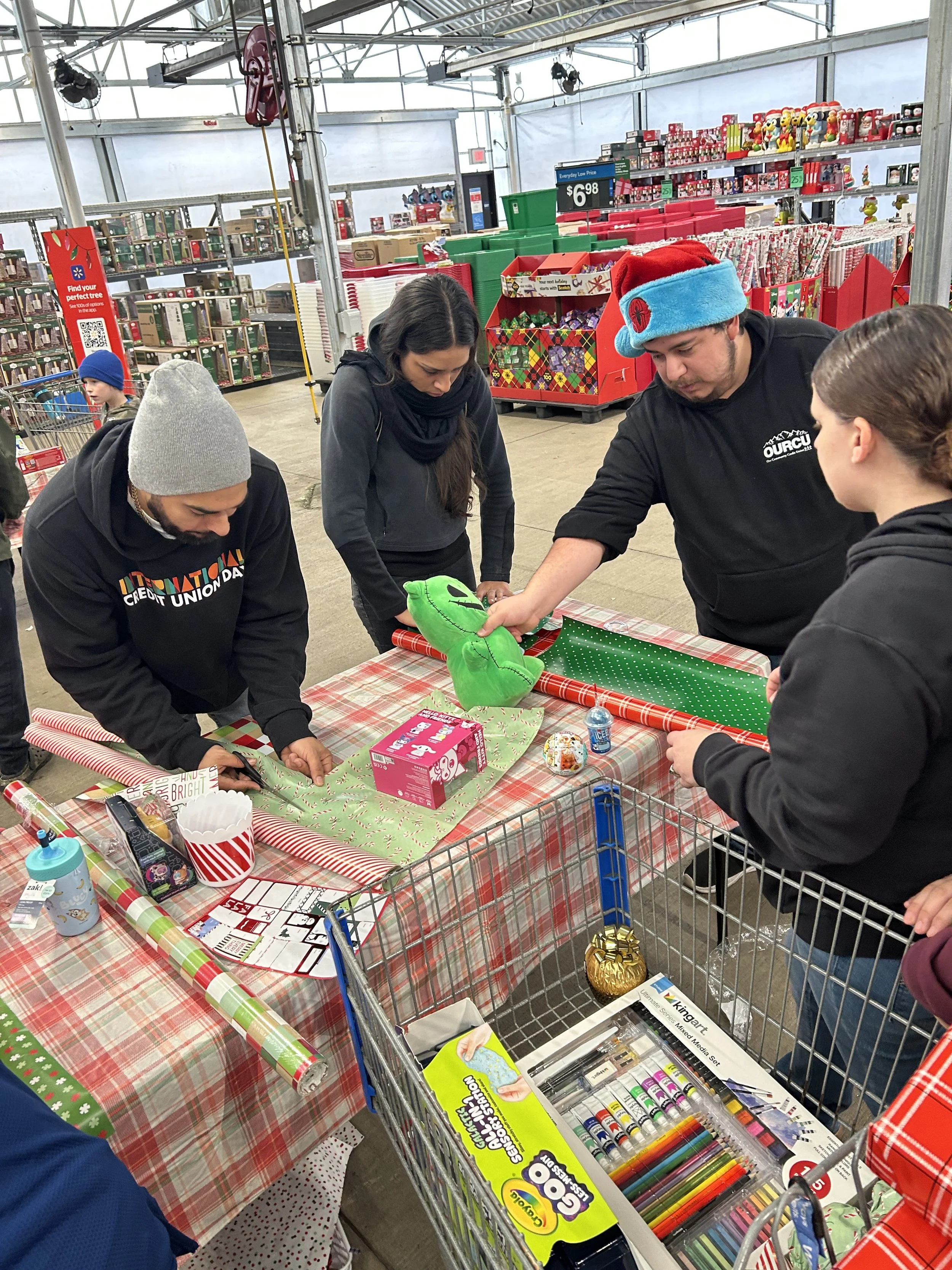 OURCU Staff volunteering to wrap gifts during Shop with Cop Event Shelton