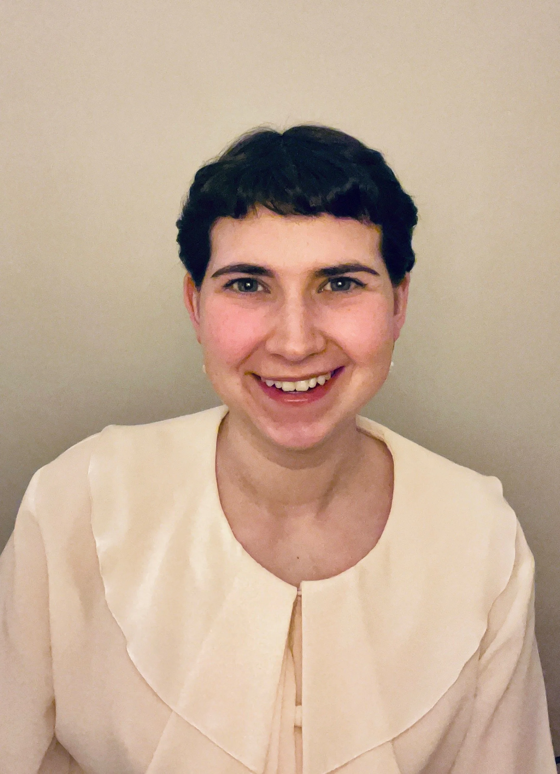 young white appearing individual with tan shirt 