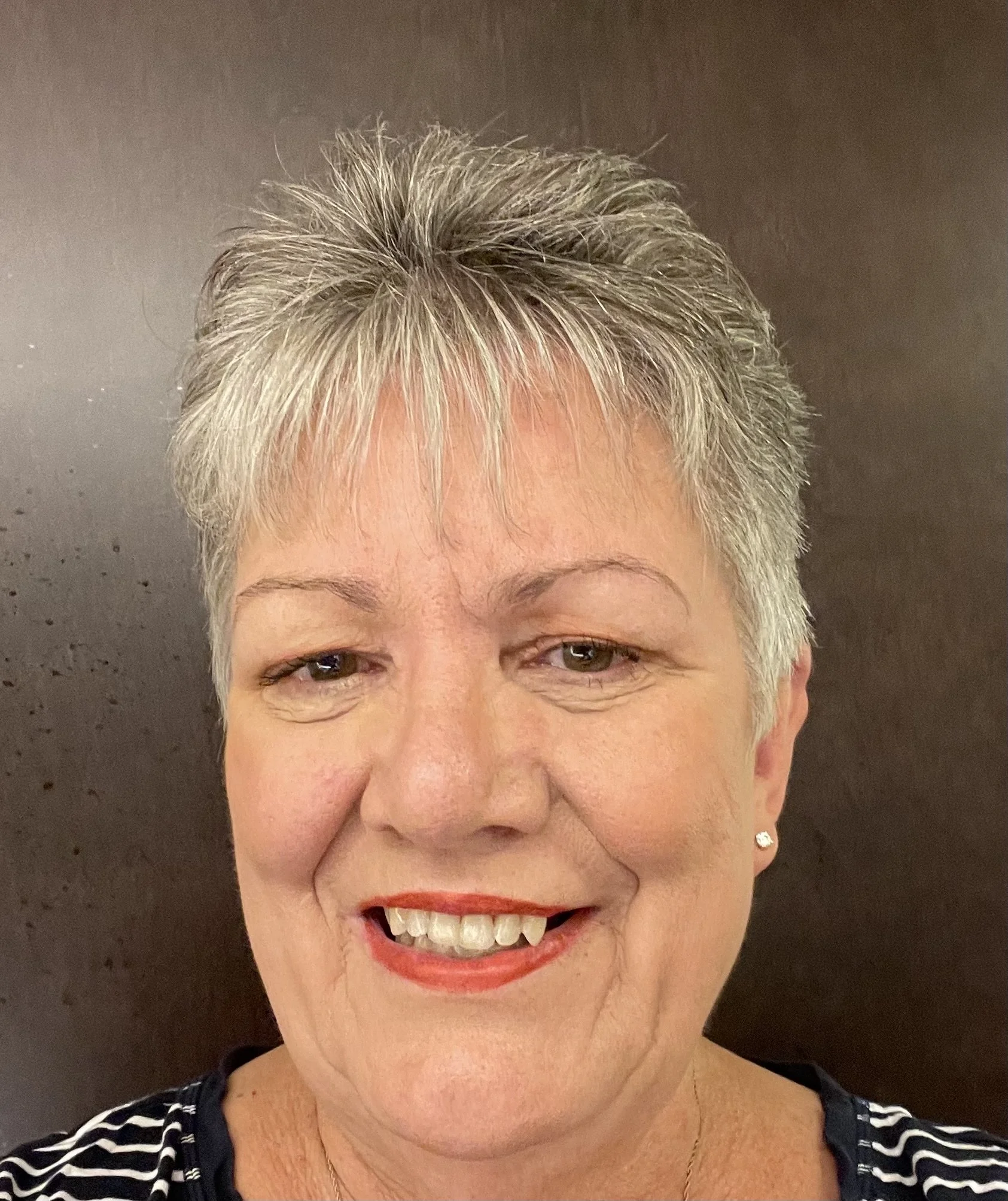Woman with grey and white hair and red lipstick