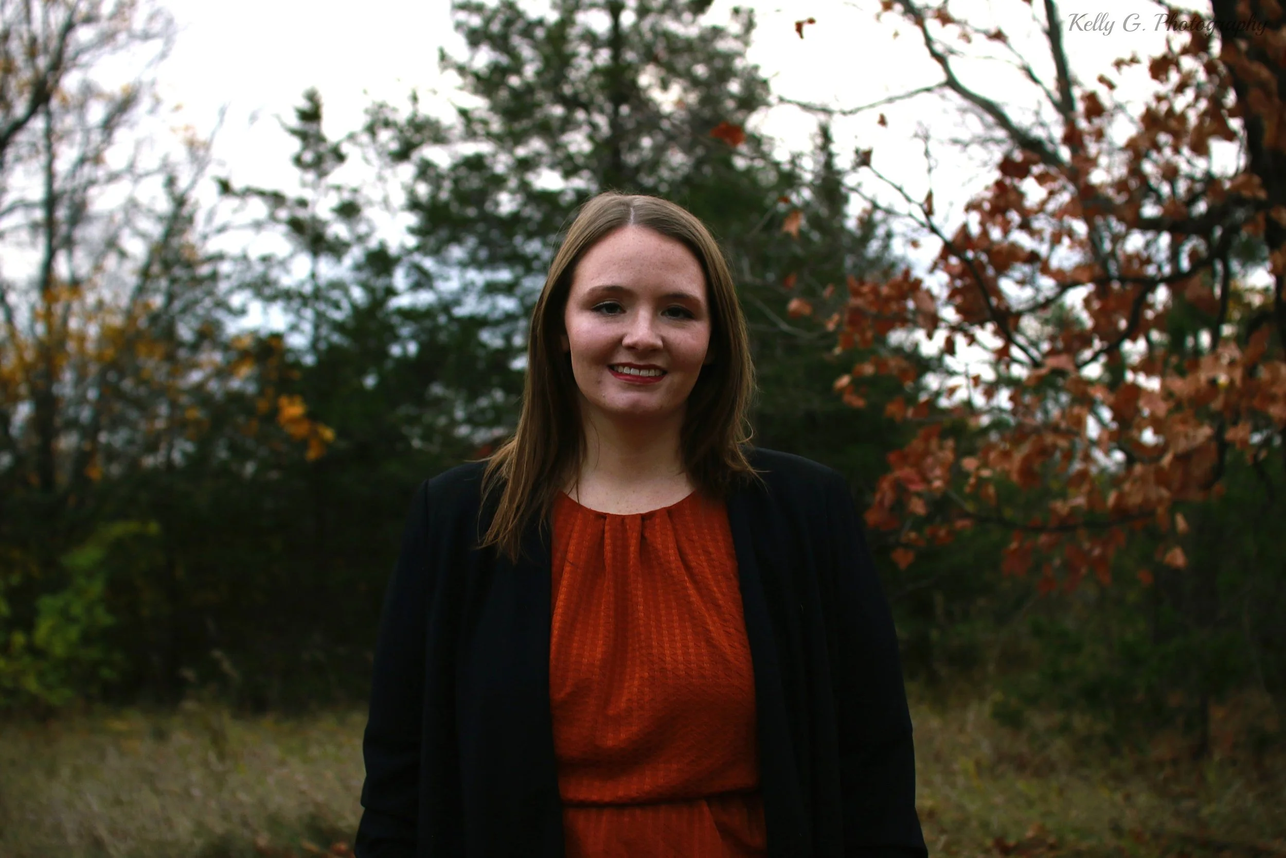 women with light brown hair and orange shirt 