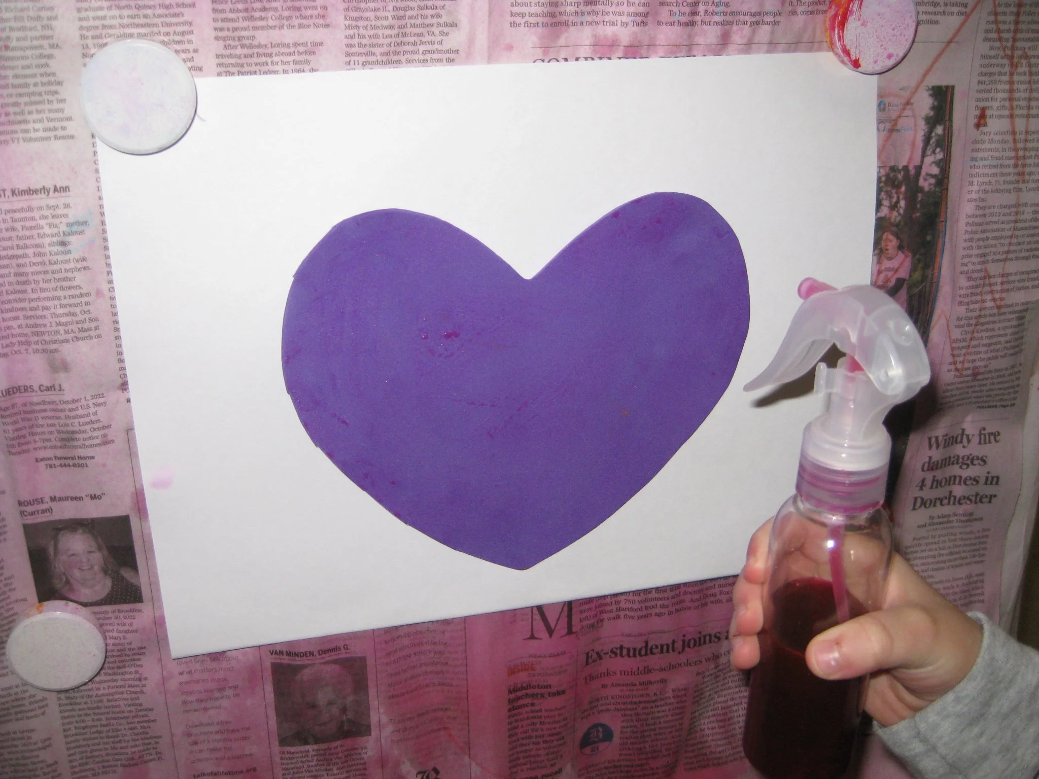 Watercolor in spray bottle at easel.