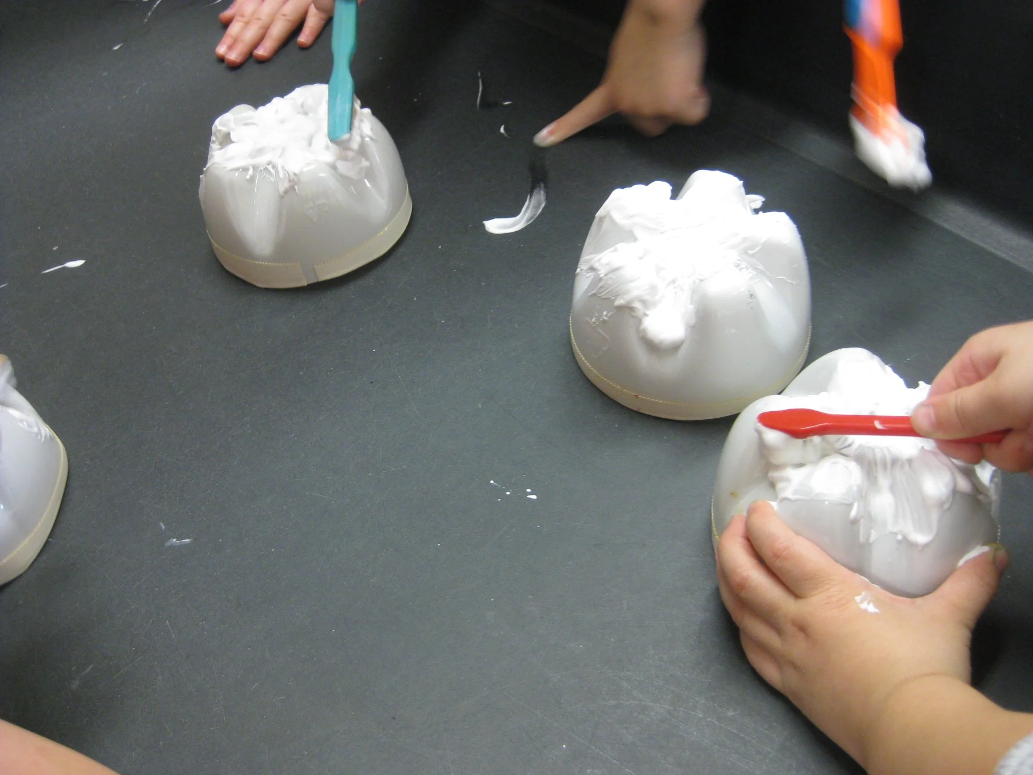 Cleaning teeth with shaving cream toothpaste.