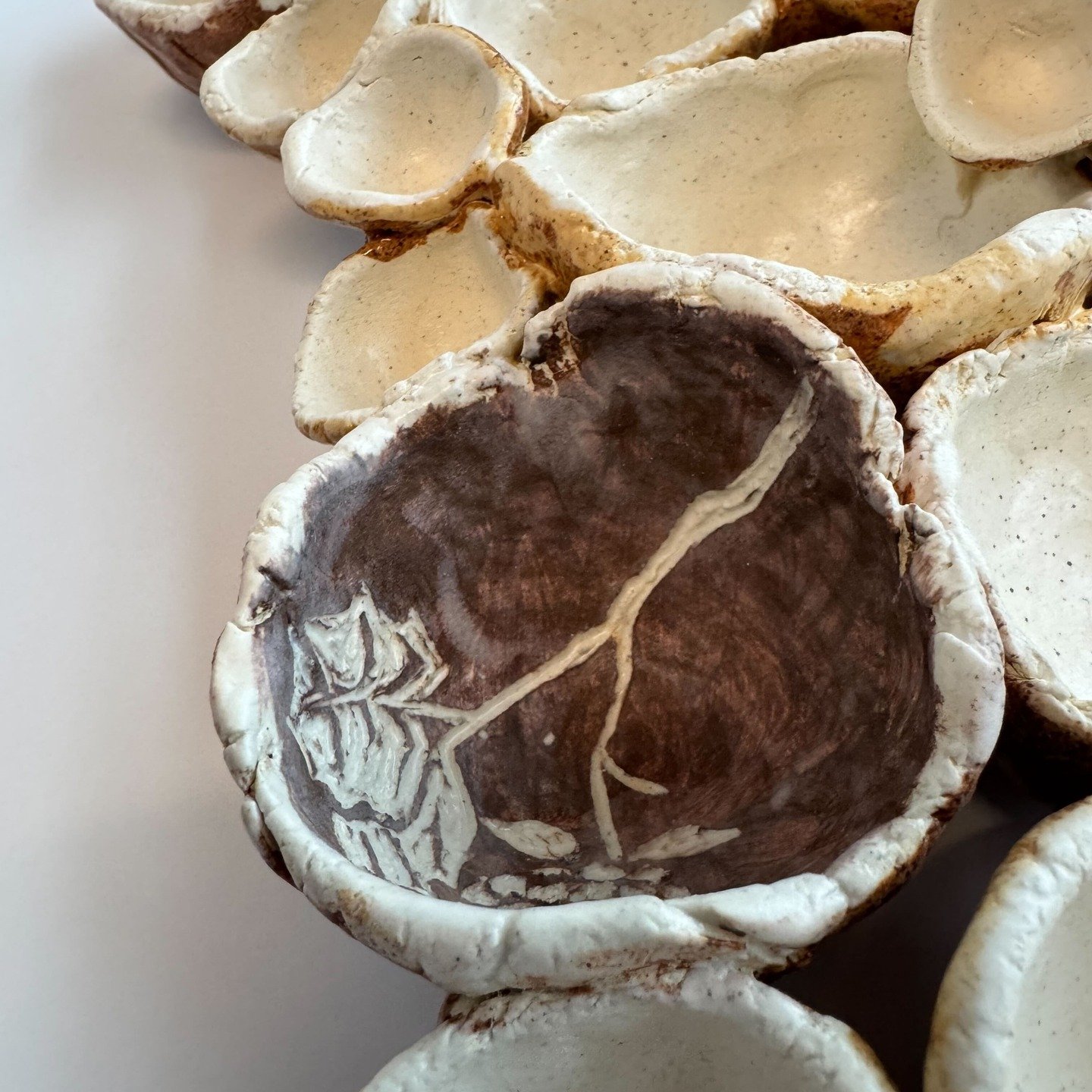 I experimented with a lot of glaze options until I settled on this very moody matte clear, which sometimes works too well and frosts over everything. Here though, it perfectly complemented my sgraffito work.