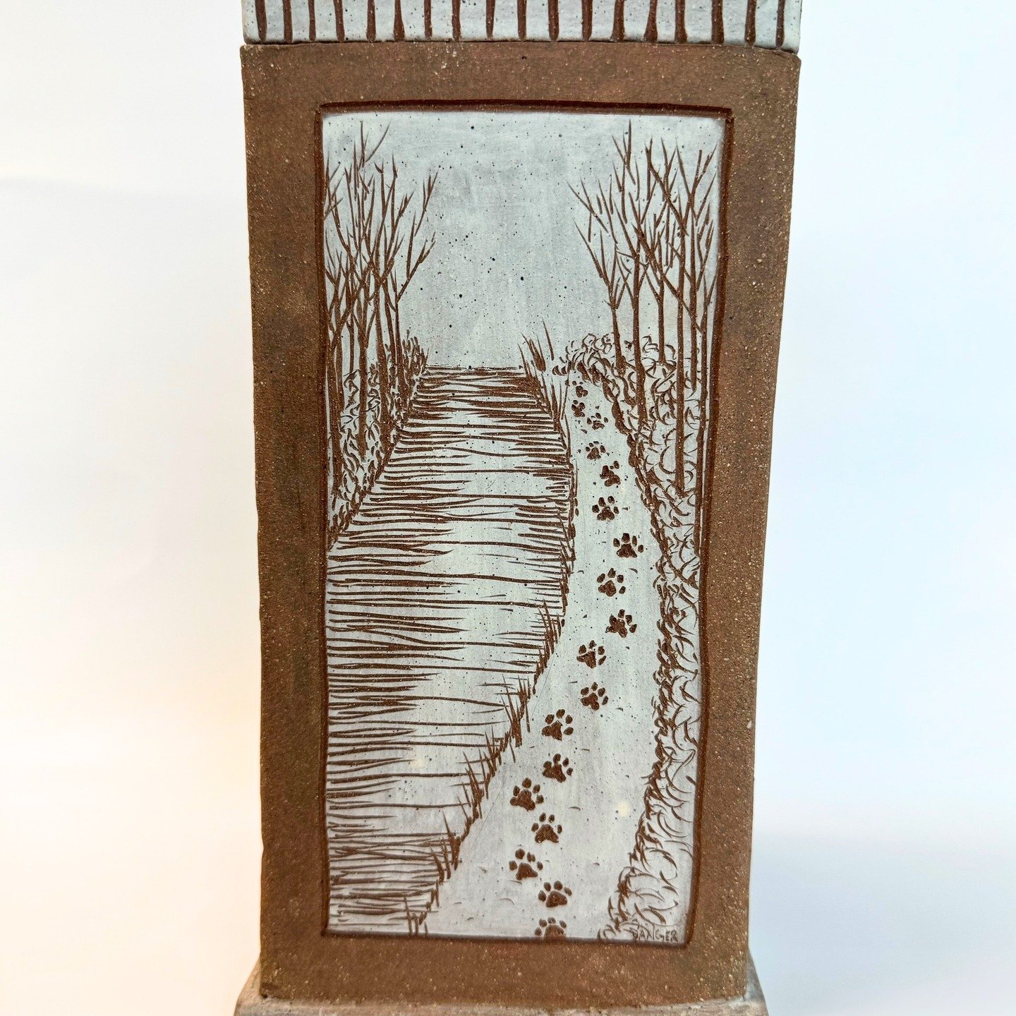 This four-sided urn was a special piece made for a very special dog named Charlie. 

Charlie was not my dog, but I was madly in love with him. You couldn't meet Charlie without falling in love. Charlie was one of those dogs who brings you peace just 