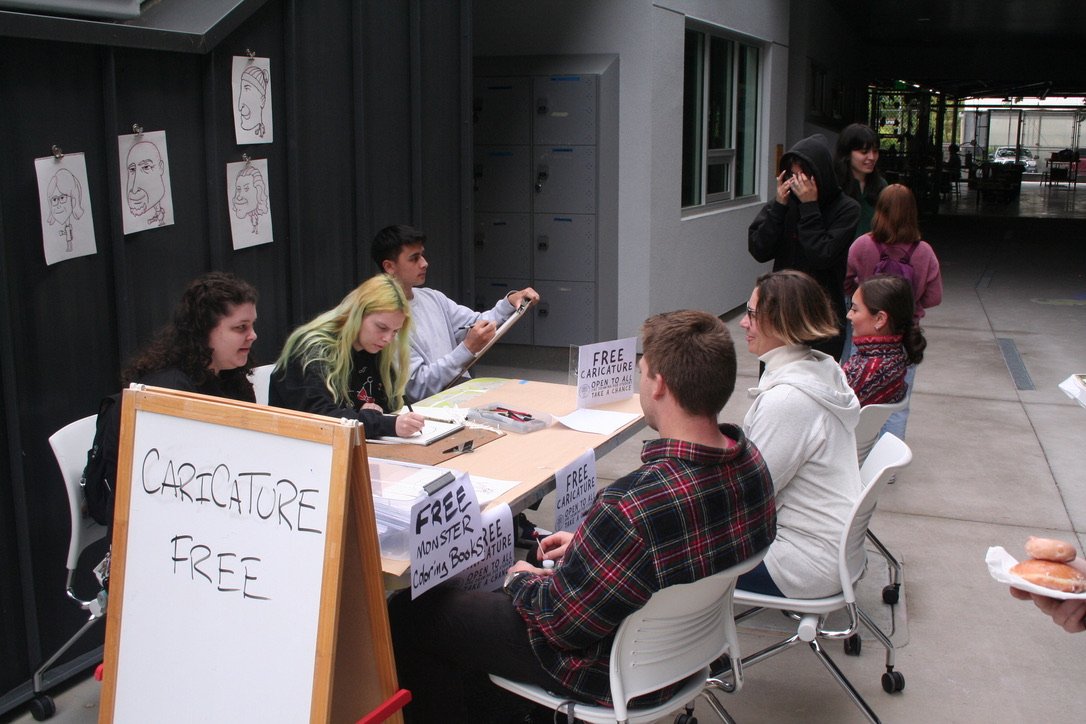 Students drawing caricatures