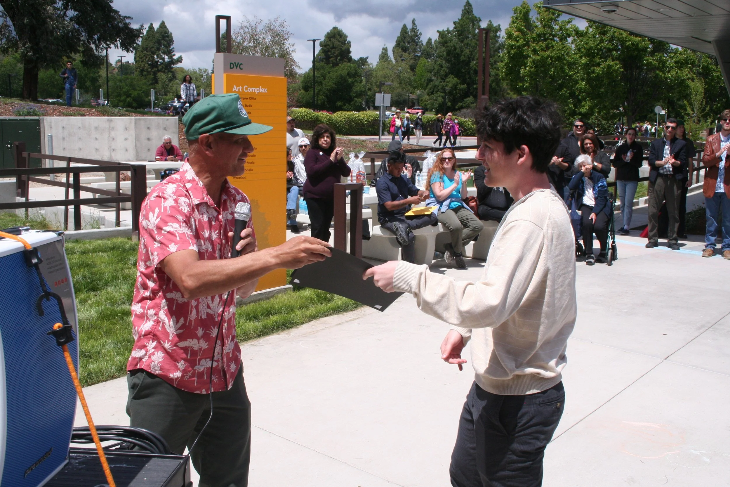  Faculty member, Leo Bersamina handing out an award to a student.