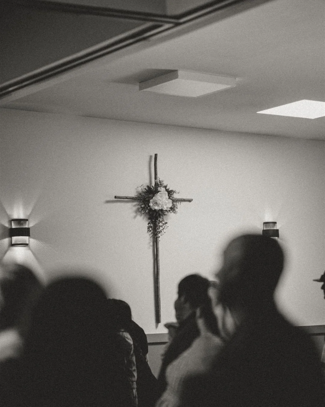 A cross once marked by suffering&hellip;
now filled with beauty.

Flowers on the cross.
Worship in the room.
A reminder that Jesus makes all things new.