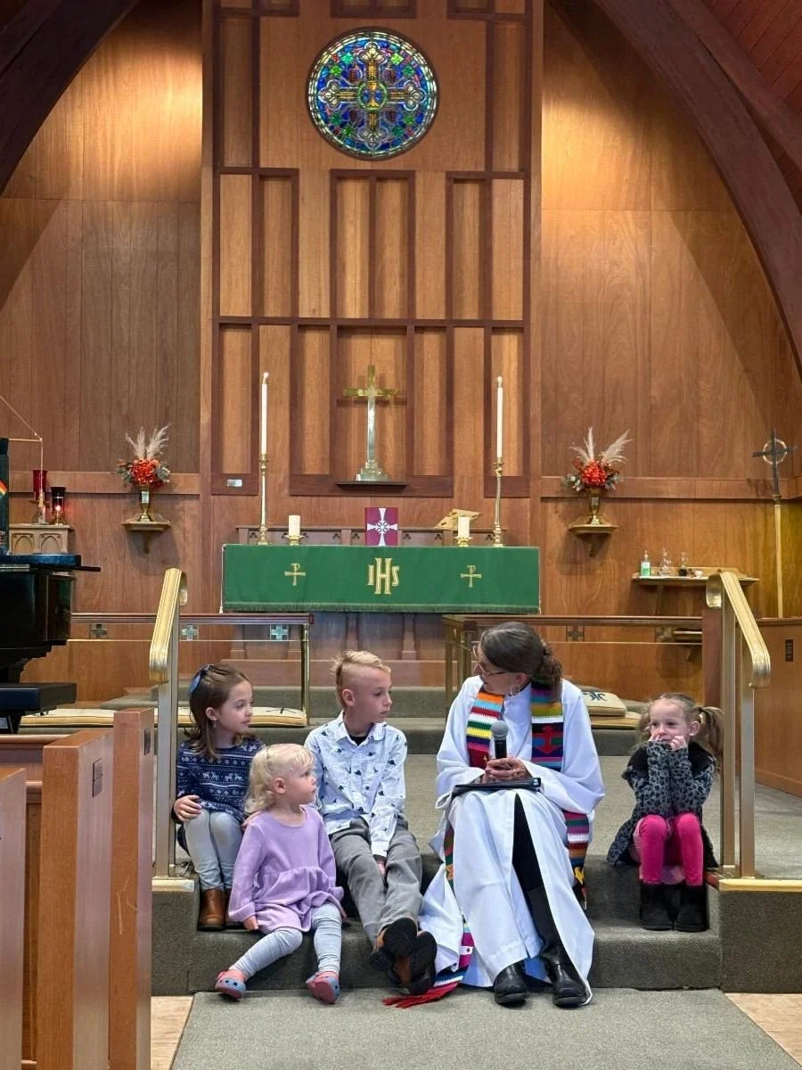Rev. Kimberly sitting with children