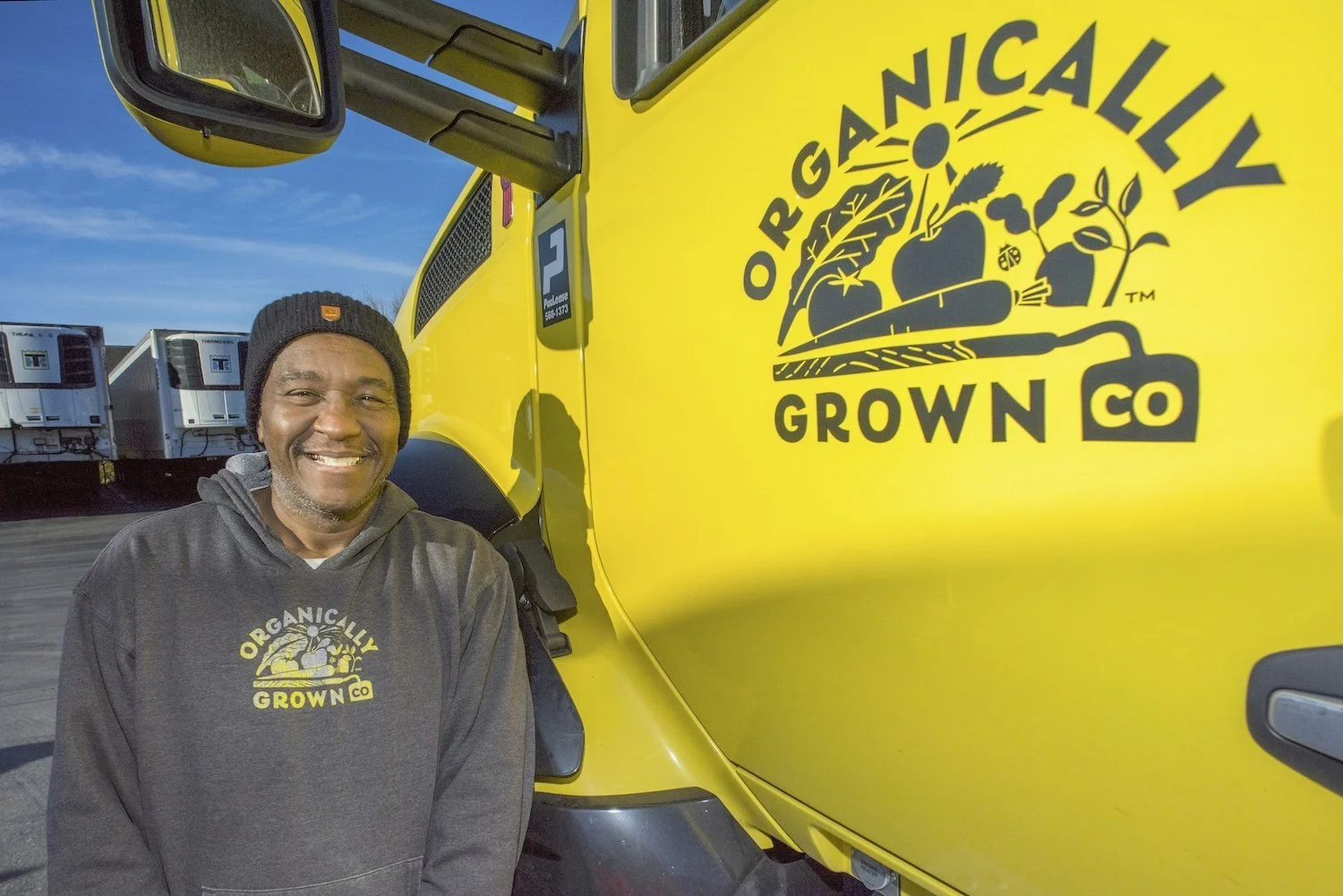 OGC Truck driver standing next to semi-truck