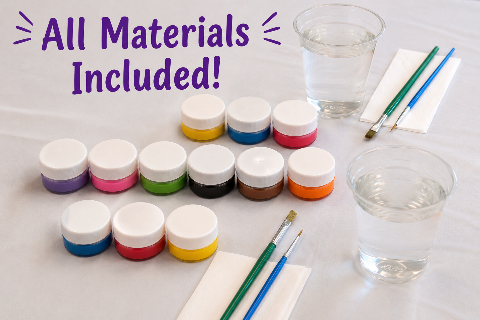 Assorted jars of paint in various colors, two glasses of water, and paintbrushes on a table, with an overlay text saying 'All Materials Included!'