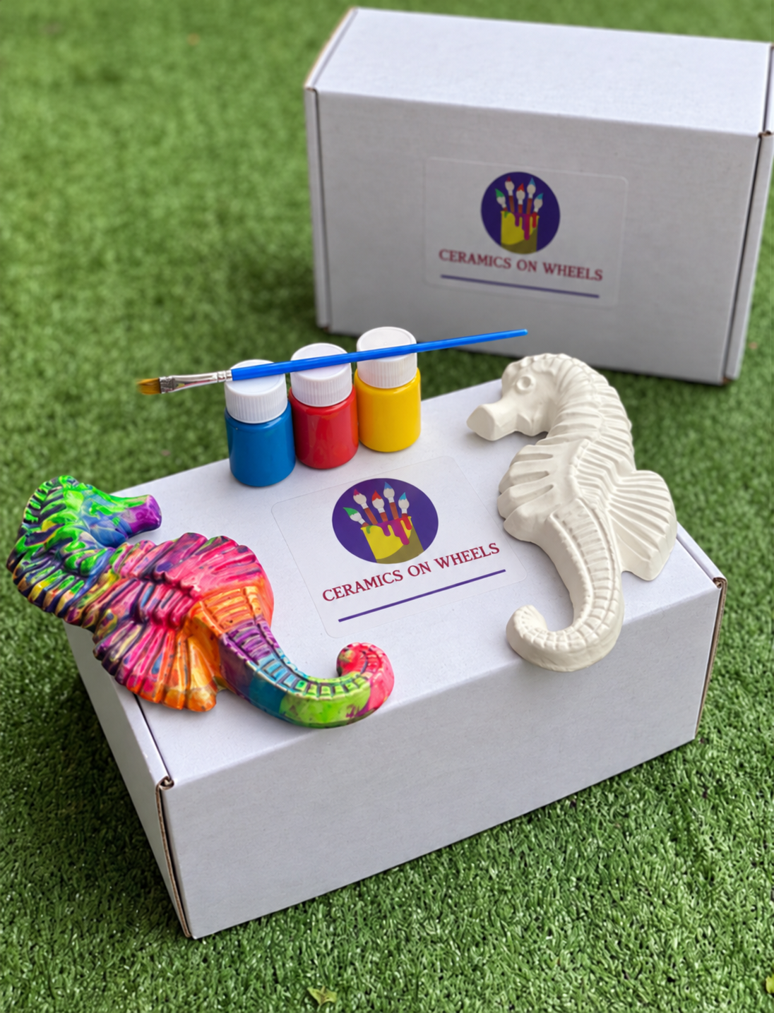 Seahorses and paint bottles on white boxes.png