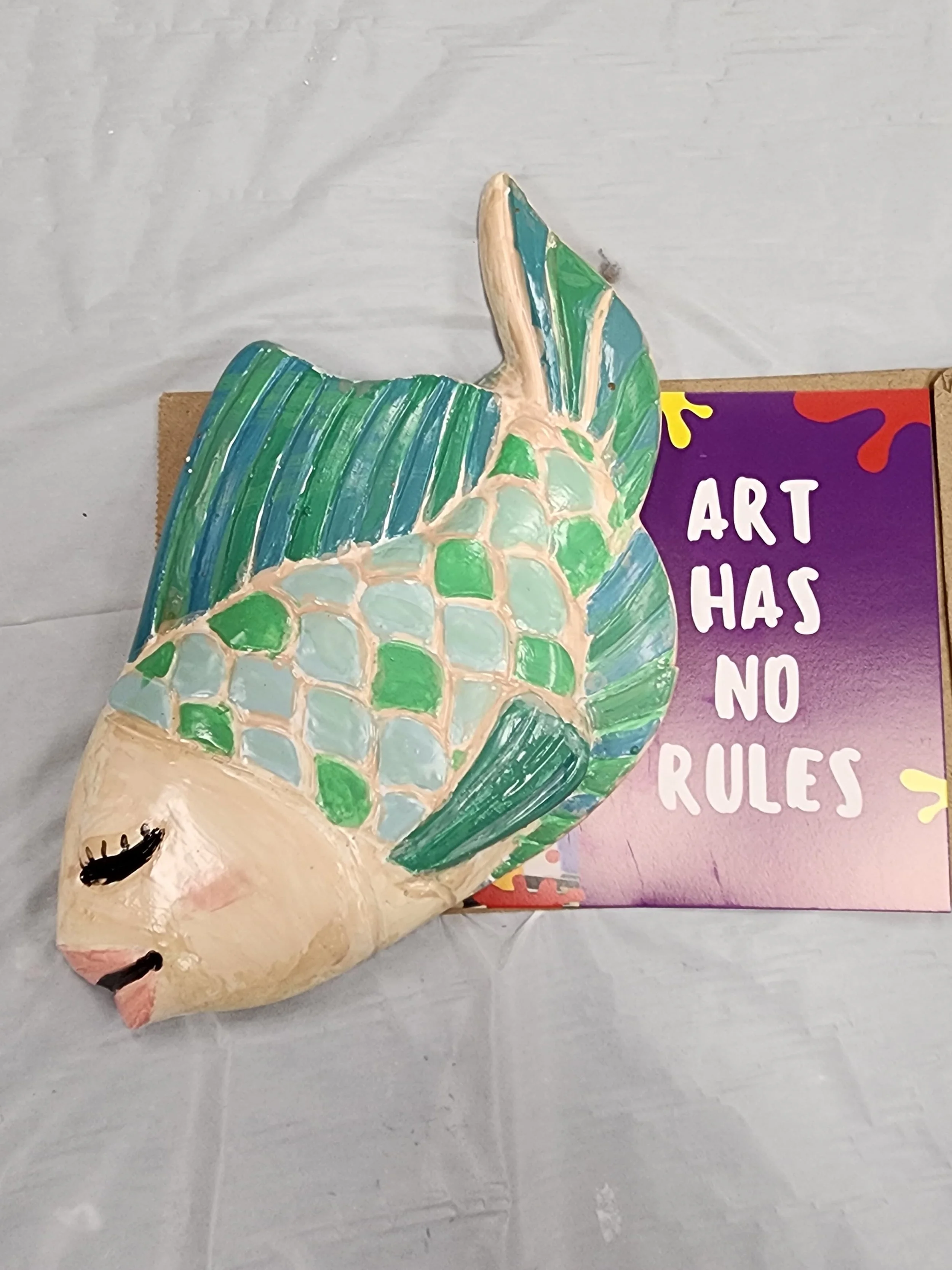 ceramics on wheels art project blue green and cream content fish plaster art