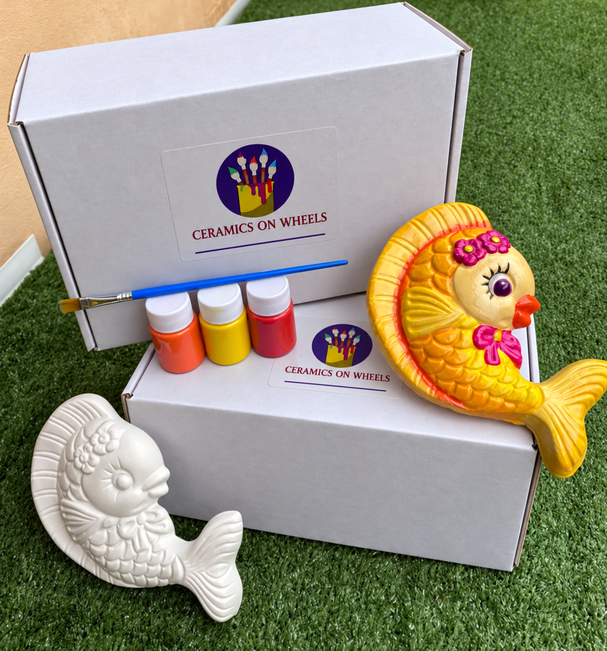 Ceramic fish and stacked white boxes.png