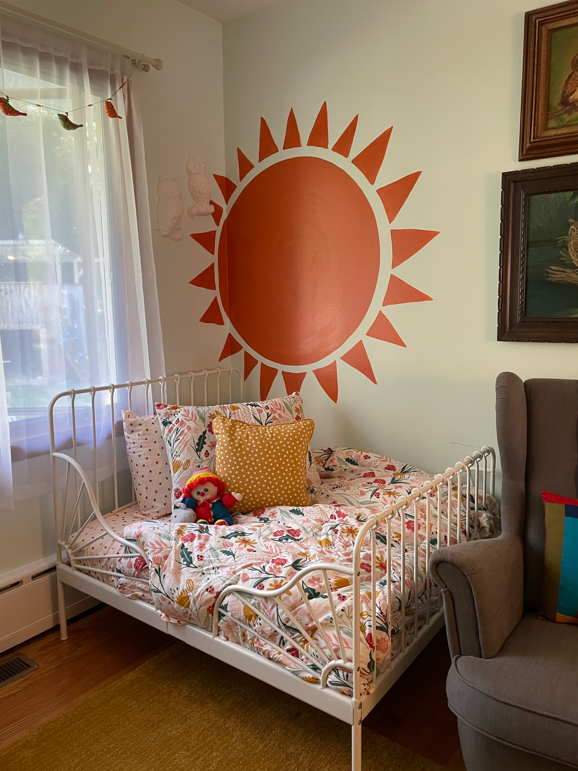 Rainbow and Sun Detail: this bohemian style mural adorns a shared bedroom