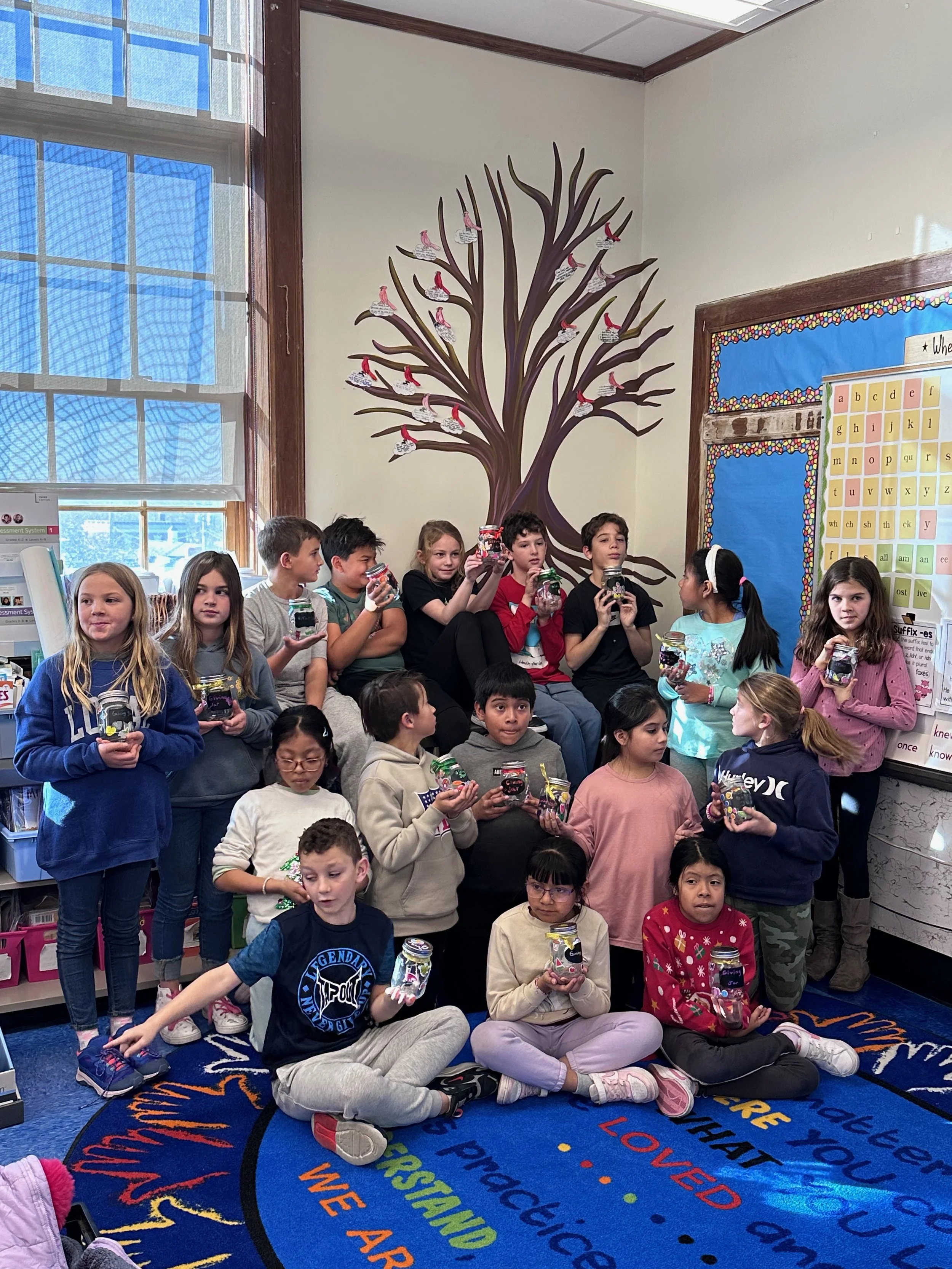Ms. Hamill's Tree: a bloomless, leafless tree adorns the corner of Ms. Hamill's fourth grade classroom. Students are encouraged to add artwork and other projects to the branches throughout the seasons.