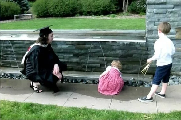 Rachel at her graduation, with kids
