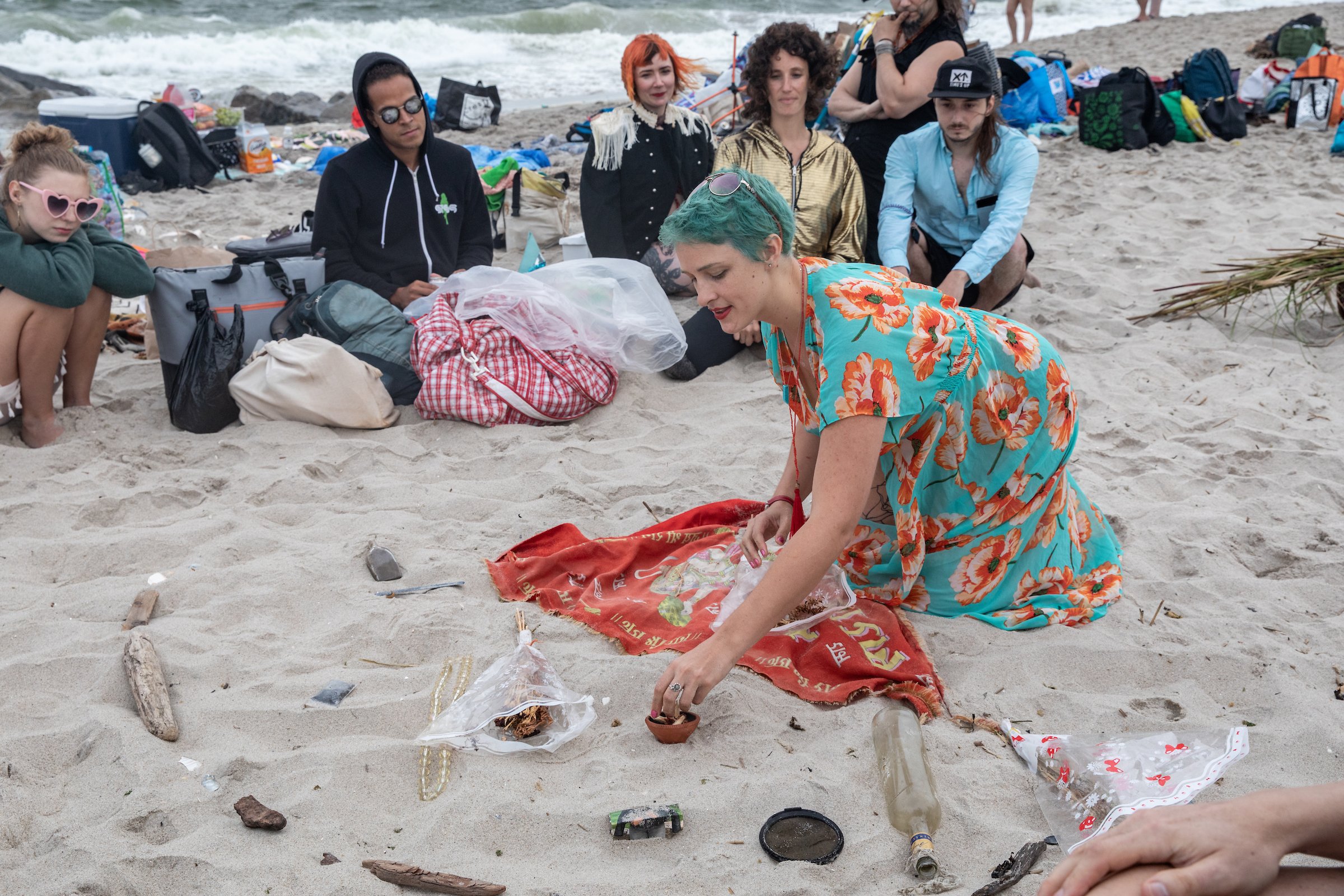 Misha Meyer tells a story from objects found washed ashore on our Beach Cleanup Day. Photo by Walter Wlodarczyk