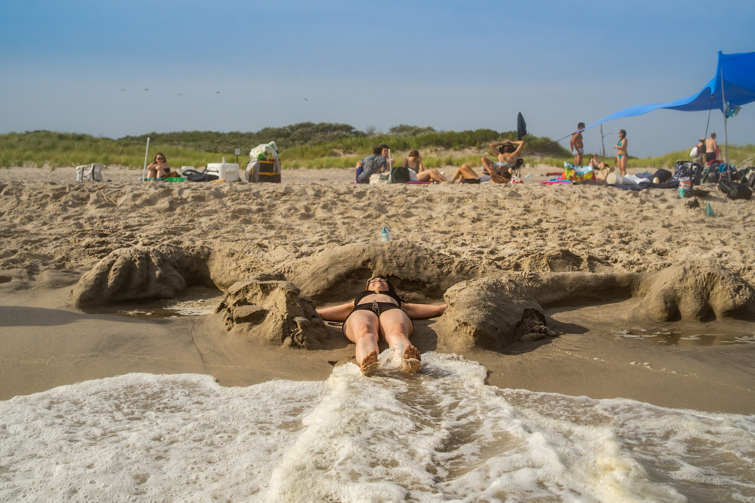 Kate Brehm performs inside of her Womb piece as it washes away. Photo by Jack Cavicchi