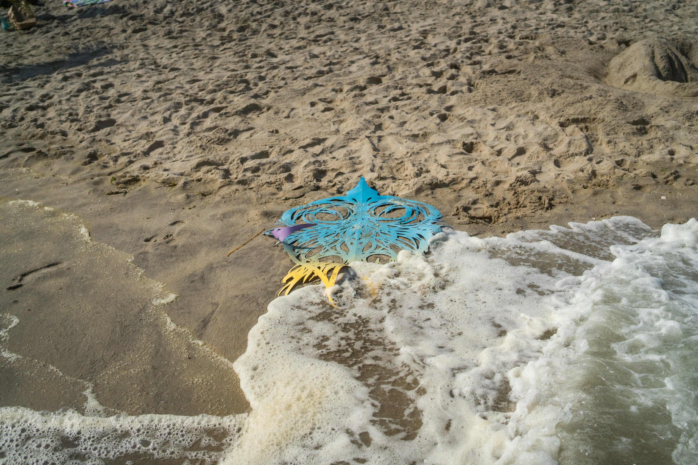 Mor and her floating sculpture (lifted out of the sea before it washed away). Photo by Jack Cavicchi.