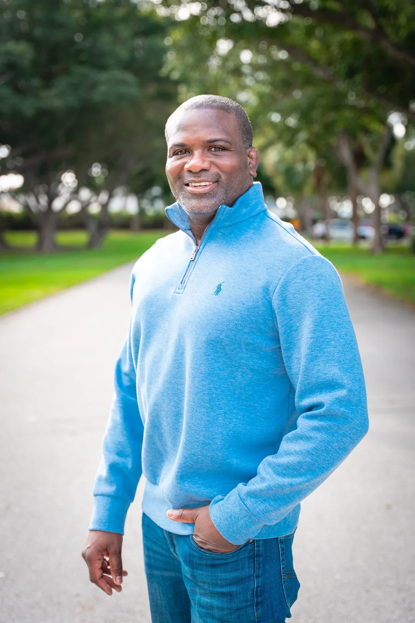 Professional headshot of a man against a neutral background