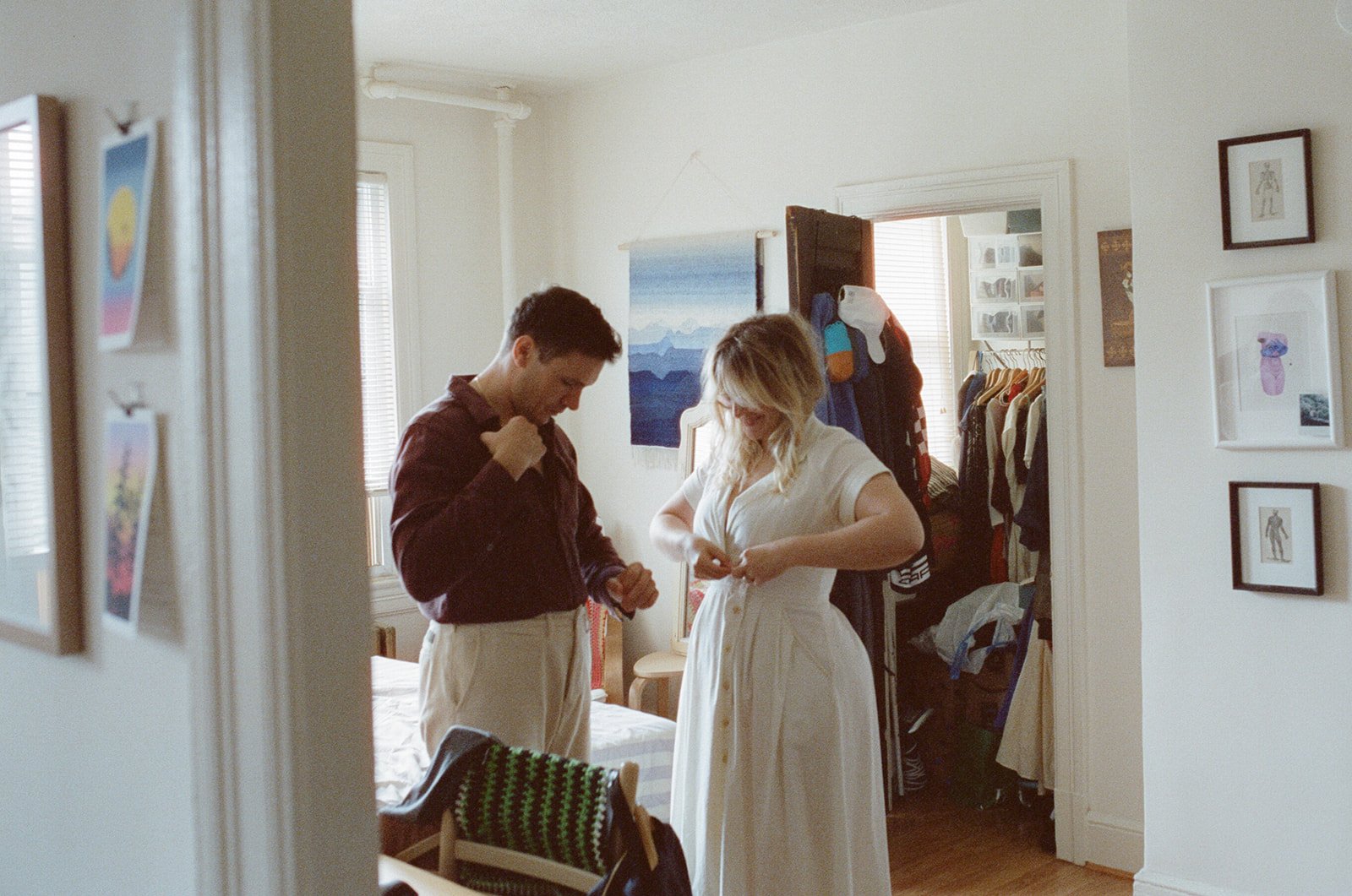 man and woman getting dressed in their bedroom 