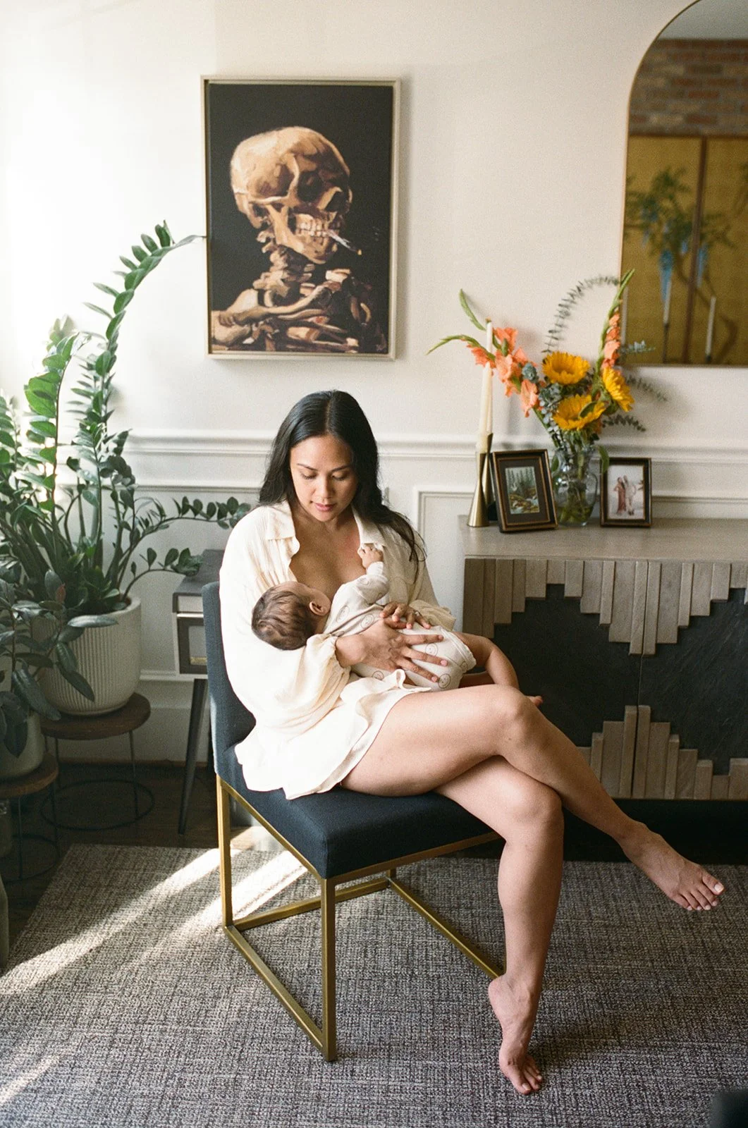 mom breastfeeding her infant child while posing for a portrait during an at home photography session with film photographer Rachel Larsen Weaver 