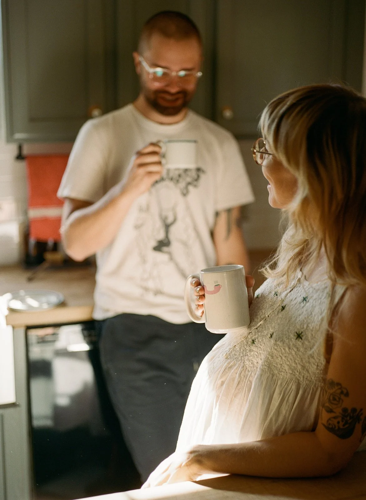 parents have their morning coffee in the kitchen during an in home family session with Rachel Larsen Weaver