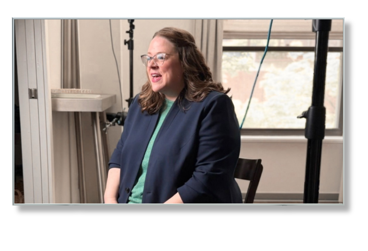 Sarah being interviewed with cameras and lights