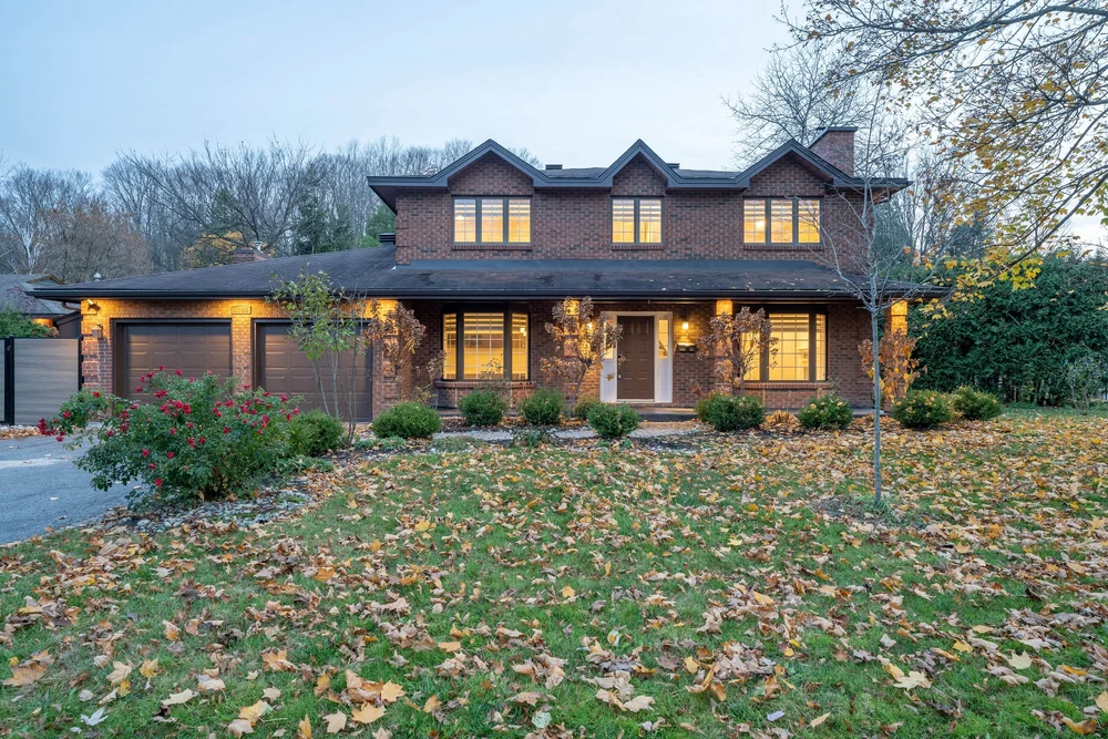 Two-story brick property photographed at dusk by NVISION 3D