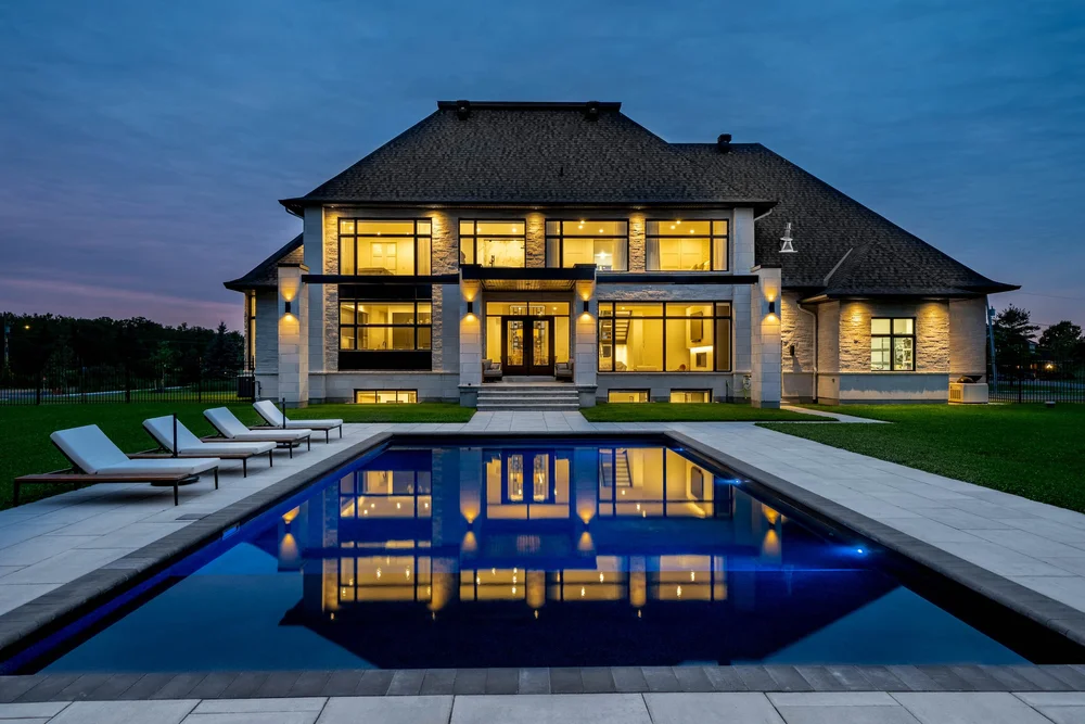Contemporary home exterior photographed by NVISION 3D at dusk with illuminated windows