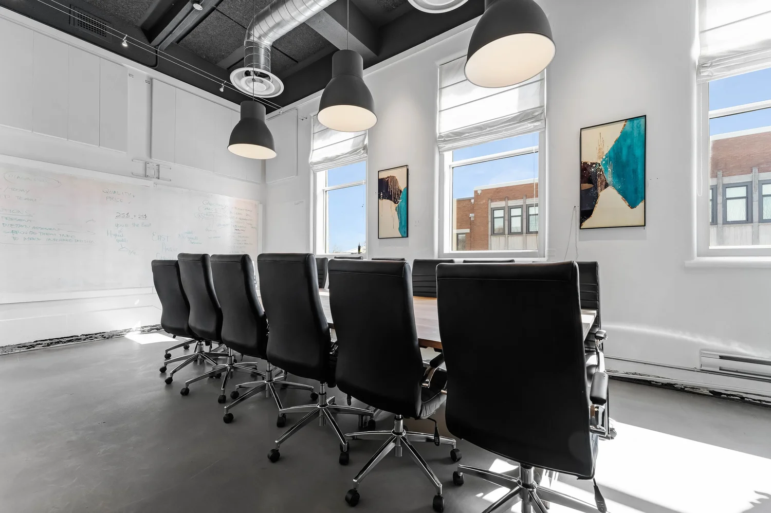 Bright commercial conference room with a long wooden table and large windows, photographed by NVISION 3D