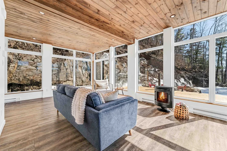 Living room with blue sofa and timber ceiling photographed by NVISION 3D