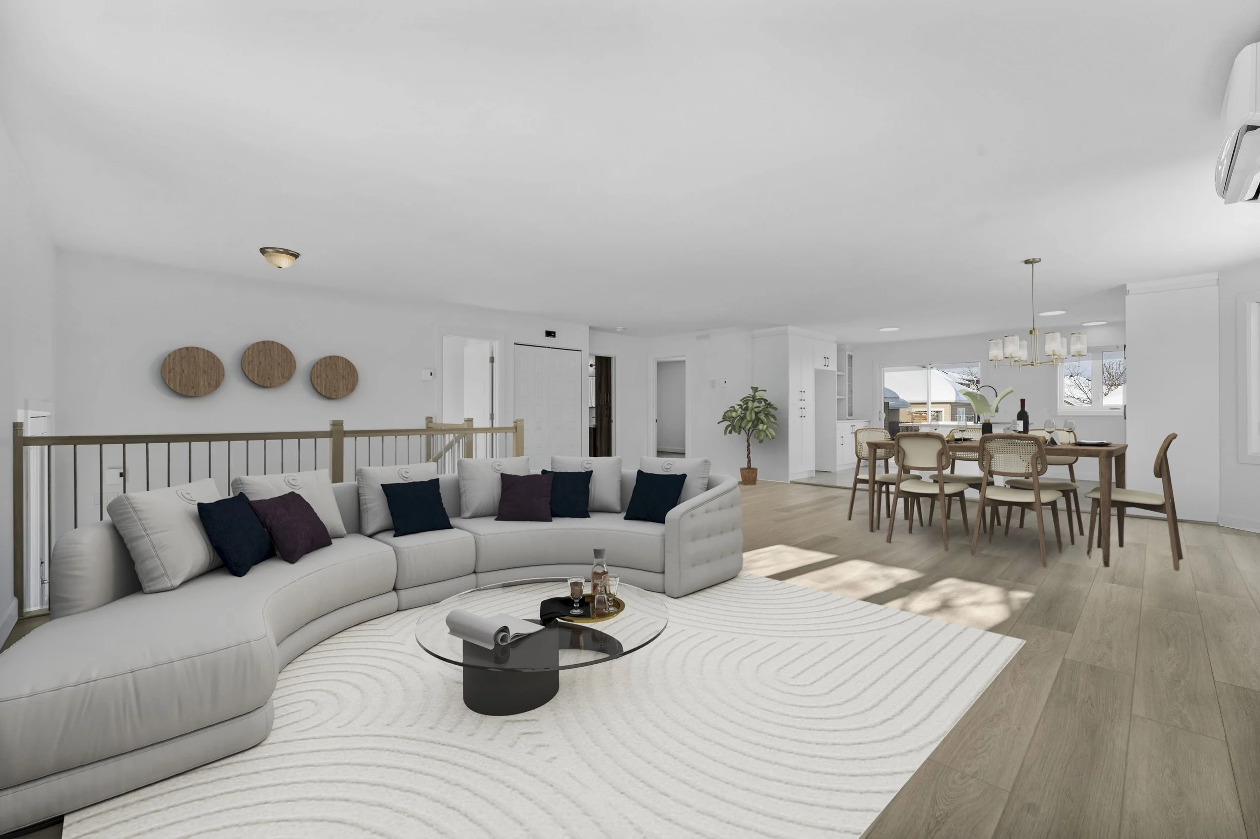 Bright and spacious open-concept living and dining area with white walls, a large white curved sectional sofa with purple and navy throw pillows, a round black coffee table, a white rug with circular patterns, and a wooden dining table with beige cha