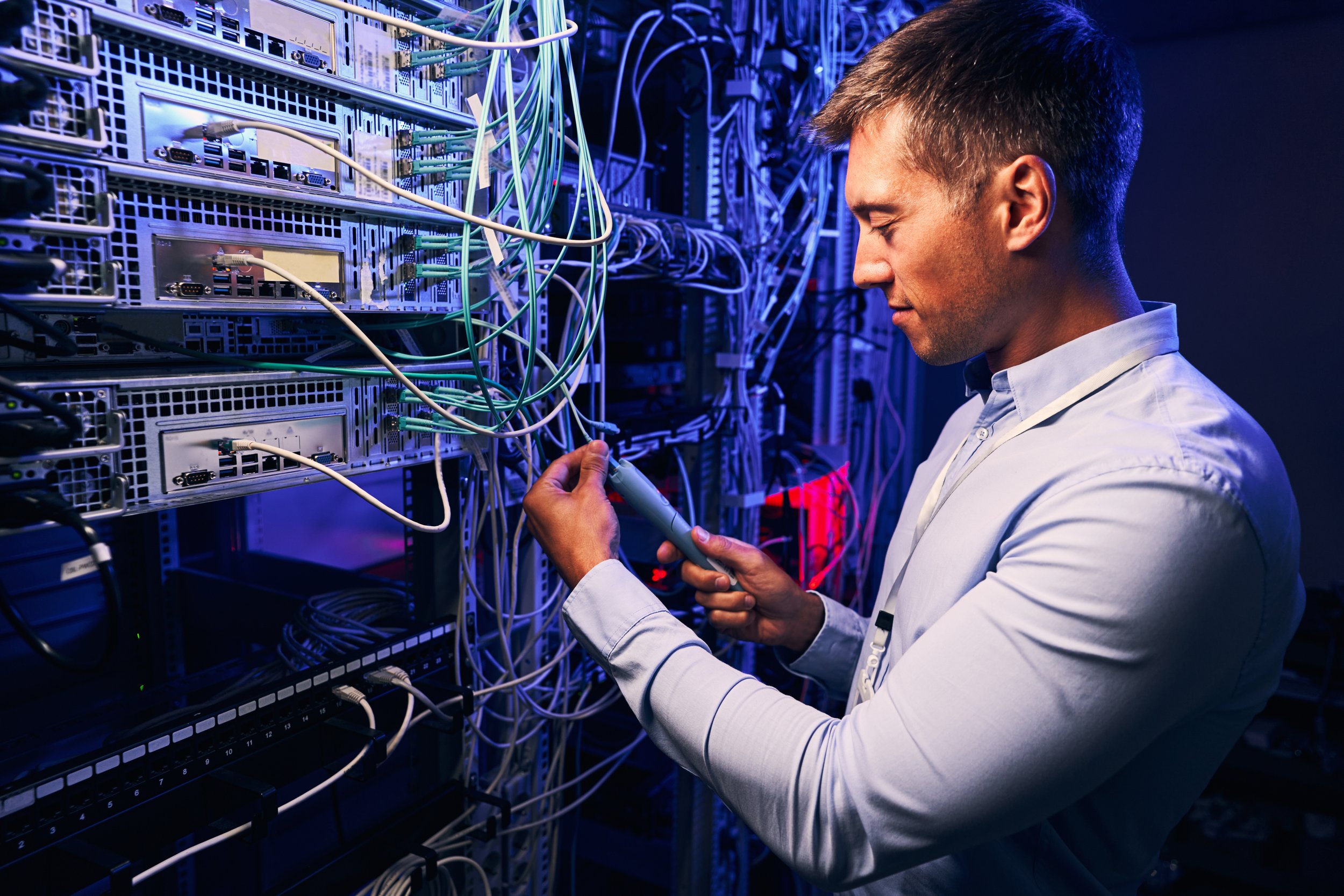 focused-data-center-employee-checking-cabling-infr-2024-10-18-08-46-41-utc.jpg