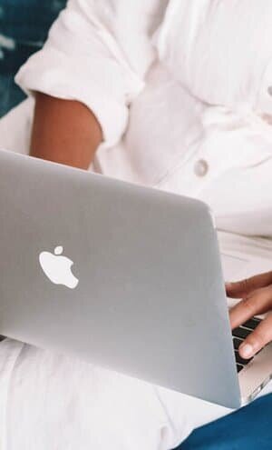 person typing on laptop to research online resources and courses