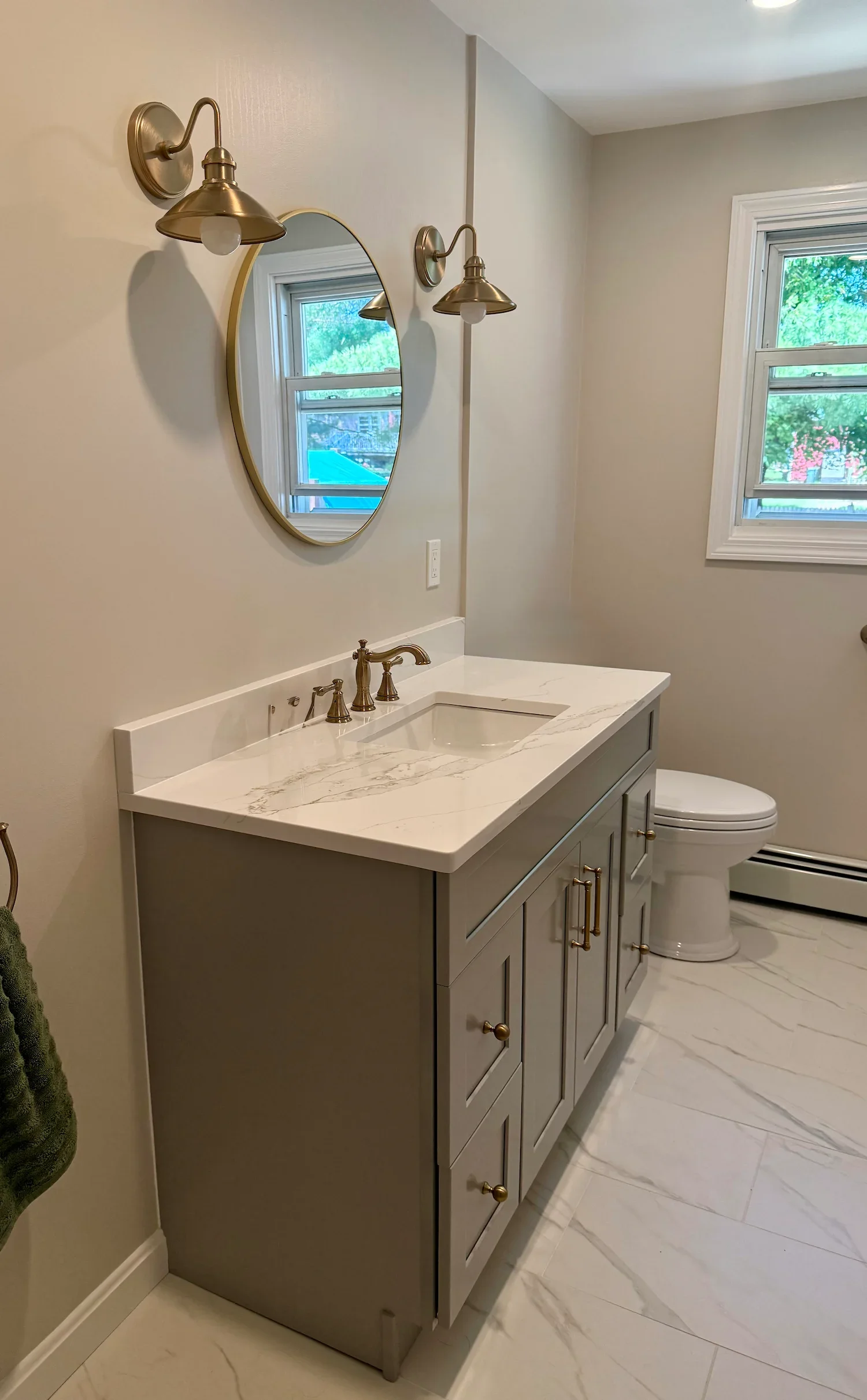 Gray vanity with marble top and brass sconces bathroom remodel North Shore MA
